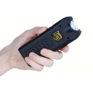 A hand holding a black stun gun